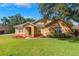 Charming single-story home featuring well-manicured lawn, mulch beds, and a welcoming front entrance at 2619 Breezy Meadow Rd, Apopka, FL 32712