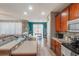 Modern kitchen with wooden cabinets and stainless steel sink leading to a living space at 2619 Breezy Meadow Rd, Apopka, FL 32712