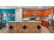 Kitchen island with breakfast bar seating, wooden cabinets and stainless steel appliances at 2619 Breezy Meadow Rd, Apopka, FL 32712