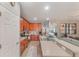 Open-concept kitchen featuring wooden cabinets and stainless steel appliances at 2619 Breezy Meadow Rd, Apopka, FL 32712