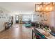 Spacious living room featuring tile floors, an egg chair and a formal dining area at 2619 Breezy Meadow Rd, Apopka, FL 32712