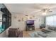 Comfortable living room features a ceiling fan, large TV and a soft couch at 2619 Breezy Meadow Rd, Apopka, FL 32712
