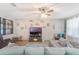 Cozy living room features a ceiling fan, large TV and a sectional sofa at 2619 Breezy Meadow Rd, Apopka, FL 32712
