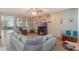 Open living room with sectional sofa and display shelving at 2619 Breezy Meadow Rd, Apopka, FL 32712