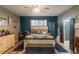 Spacious main bedroom with stylish decor, gray and blue color scheme, and ensuite bathroom at 2619 Breezy Meadow Rd, Apopka, FL 32712