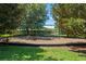 Community swing set area covered in mulch and surrounded by mature trees at 2619 Breezy Meadow Rd, Apopka, FL 32712
