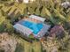 Aerial view of a community pool with shade coverings and lounge chairs at 2619 Breezy Meadow Rd, Apopka, FL 32712