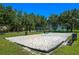 A community volleyball court with lush green grass and mature trees at 2619 Breezy Meadow Rd, Apopka, FL 32712