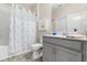 Bright bathroom featuring a shower-tub combo, white and grey vanity, and nautical decor at 3007 Caneel St, Winter Haven, FL 33884