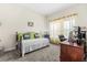 Comfortable bedroom with a bed, work desk, and bright natural light from the window at 3007 Caneel St, Winter Haven, FL 33884
