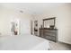 Bright bedroom with a large dresser, neutral walls, and an ensuite bathroom, creating a relaxing retreat at 3007 Caneel St, Winter Haven, FL 33884