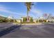 Stately clubhouse entrance with circular driveway, mature landscaping and a center island with palm tree at 3007 Caneel St, Winter Haven, FL 33884