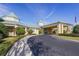 Entrance to the grand clubhouse with porte cochere, roundabout driveway, and immaculate landscaping at 3007 Caneel St, Winter Haven, FL 33884