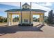 A stately community entrance adorned with palm trees and a yellow-and-white color scheme at 3007 Caneel St, Winter Haven, FL 33884