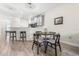 Cozy dining area with wood-look tile flooring, a small table with seating for four, and a view of the kitchen at 3007 Caneel St, Winter Haven, FL 33884