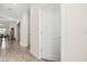 Bright hallway with wood-look flooring and doorways leading to various rooms in the house at 3007 Caneel St, Winter Haven, FL 33884