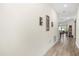 Bright hallway featuring light-colored walls, wood floors, and decorative wall sconces leading into the home at 3007 Caneel St, Winter Haven, FL 33884