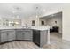 Open kitchen concept with stainless steel appliances and bar seating that opens to the living room at 3007 Caneel St, Winter Haven, FL 33884