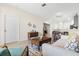 Open-concept living area with view of dining and kitchen, light-filled space with neutral tones and tile floors at 3007 Caneel St, Winter Haven, FL 33884