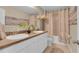 Well-lit bathroom featuring double sinks and a shower with patterned curtains at 316 Primrose Dr, Davenport, FL 33837