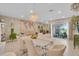 Elegant dining area with a chandelier and sliding door access to the screened porch at 316 Primrose Dr, Davenport, FL 33837