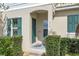 Inviting front entrance featuring a covered porch and well-manicured landscaping at 316 Primrose Dr, Davenport, FL 33837