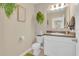 Charming half bathroom with decorative wallpaper and a modern vanity, ideal for guests at 316 Primrose Dr, Davenport, FL 33837