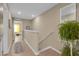 Bright hallway featuring wood floors, neutral walls, and staircase with a plant, creating a welcoming transition at 316 Primrose Dr, Davenport, FL 33837