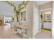 Bright hallway with neutral tones, decorative accents, and views into the living area and bathroom at 316 Primrose Dr, Davenport, FL 33837