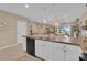 Bright kitchen with pendant lighting over the island and views of the living and dining areas for easy entertaining at 316 Primrose Dr, Davenport, FL 33837