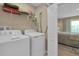 Functional laundry room with modern appliances and shelving, conveniently located near the main bedroom at 316 Primrose Dr, Davenport, FL 33837