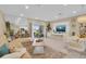 Inviting living space features a comfortable couch, entertainment unit with a TV, and adjacent dining area and sliding door at 316 Primrose Dr, Davenport, FL 33837