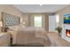 A serene main bedroom with a tufted headboard, a cozy fireplace, and a TV for relaxation at 316 Primrose Dr, Davenport, FL 33837
