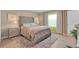 This is a bright main bedroom with a tufted headboard, neutral tones, and ample natural light at 316 Primrose Dr, Davenport, FL 33837