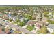 An aerial view of the property in a quiet neighborhood with manicured lawns at 321 Thomasdale Ave, Haines City, FL 33844