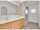 Bathroom features double sinks, vanity with natural wood cabinets, and a shower at 321 Thomasdale Ave, Haines City, FL 33844