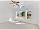 Bright and airy bedroom features large windows, carpet flooring, and a ceiling fan at 321 Thomasdale Ave, Haines City, FL 33844