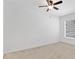 Bedroom with carpet flooring features a ceiling fan and window at 321 Thomasdale Ave, Haines City, FL 33844