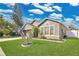 Well-manicured front yard featuring a lush lawn and colorful landscaping at 321 Thomasdale Ave, Haines City, FL 33844