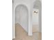 Bright hallway featuring tiled floor, neutral color palette, and arched doorways at 321 Thomasdale Ave, Haines City, FL 33844