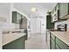 Modern kitchen featuring stainless steel appliances and green cabinets with bright lighting at 321 Thomasdale Ave, Haines City, FL 33844