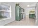 Bright kitchen with stainless steel appliances, and green cabinets at 321 Thomasdale Ave, Haines City, FL 33844