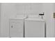 White laundry room featuring a washer, dryer, and wire shelving at 321 Thomasdale Ave, Haines City, FL 33844