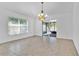 Bright living room features neutral tile flooring, updated lighting, and sliding glass doors to the lanai at 321 Thomasdale Ave, Haines City, FL 33844