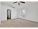 Living room with carpet flooring, ceiling fan, and archway leading to the hallway at 321 Thomasdale Ave, Haines City, FL 33844