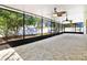 Large screened patio with tile flooring overlooks the landscaped yard at 321 Thomasdale Ave, Haines City, FL 33844