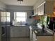 This practical kitchen features ample counter space, white cabinets, and a double sink, making meal preparation convenient at 3347 Timberline W Rd, Winter Haven, FL 33880