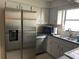 Well-lit kitchen boasting stainless steel appliances, white cabinets, and a double sink, creating a clean and efficient cooking area at 3347 Timberline W Rd, Winter Haven, FL 33880
