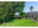 Expansive backyard featuring lush greenery and a screened-in pool area at 341 Sprucewood Rd, Lake Mary, FL 32746