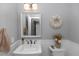 Charming bathroom with decorative mirror, stylish wreath, and pedestal sink at 341 Sprucewood Rd, Lake Mary, FL 32746